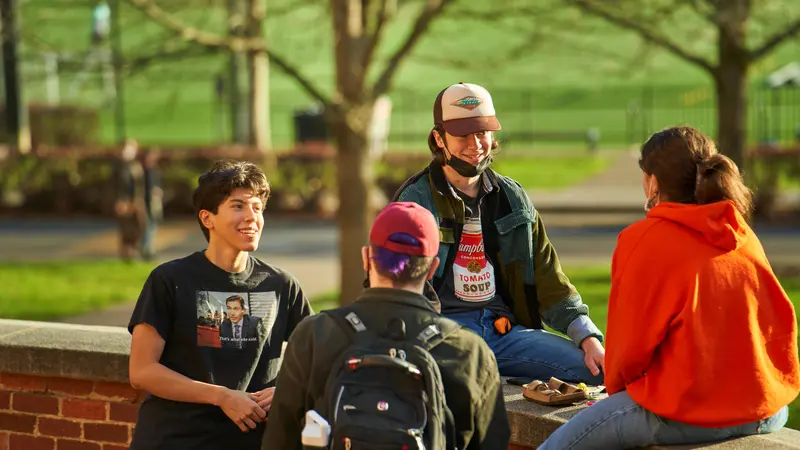 Students in a group talking. 